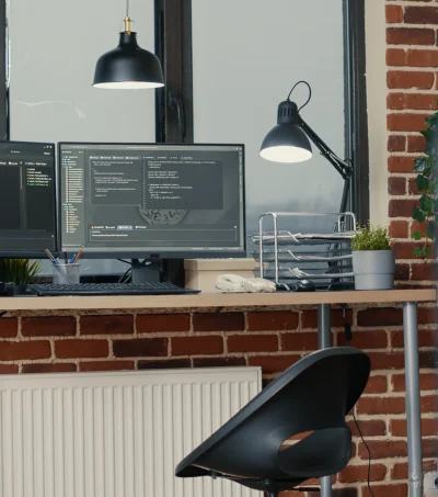 desk-with-multiple-computer-monitors-displaying-parsing-code-programming-language-compiling-empty-software-developing-agency-office-servers-cloud-computing-big-data-algorithms